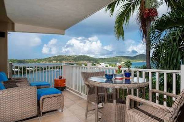 balcony view of Water Bay with outdoor dining table set for two