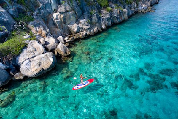 Aerial view of a woman on paddleboard in tropical water in the US Virgin Islands