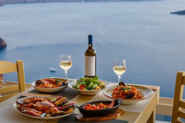 Seafood dinner for two with white white in an island setting - ocean in the background. 