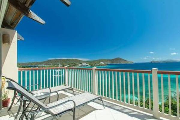 balcony view of vacation rental overlooking Caribbean blue water
