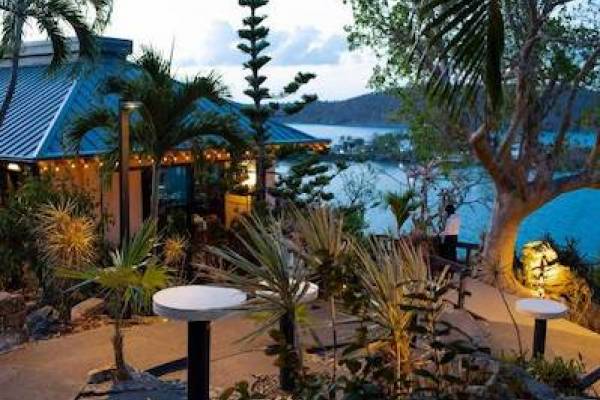 exterior of Ocean 180 restaurant with Water Bay in the background at sunset