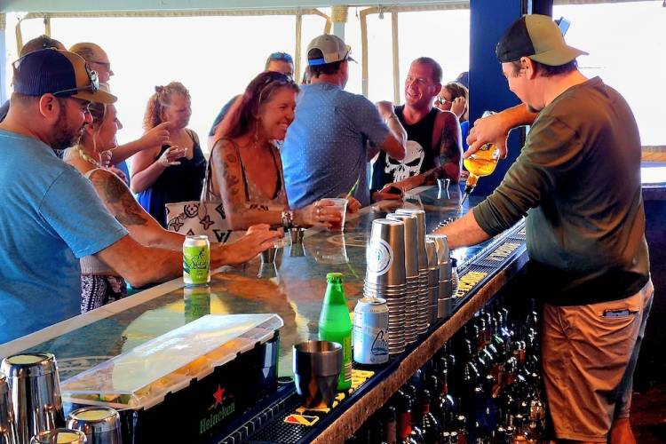 bartender pouring drinks for a full bar