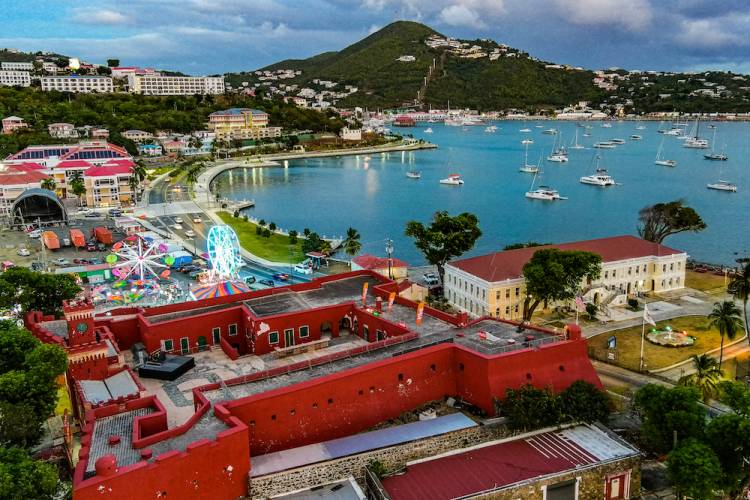 Aerial view of St. Thomas including Carnival Village, boats in the harbor and the legislative building