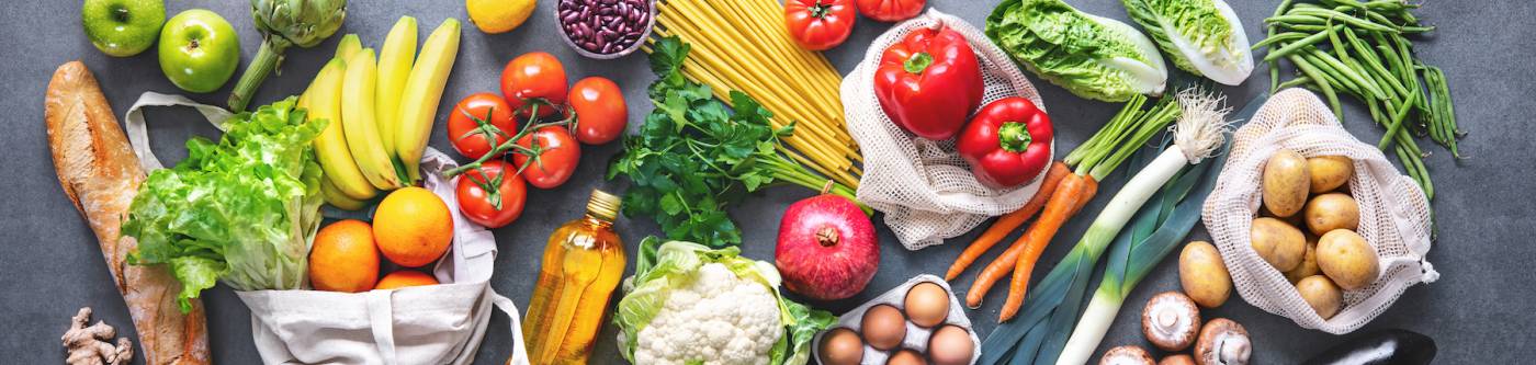 Aerial of fresh produce displayed decoratively across a dark chalky grey table